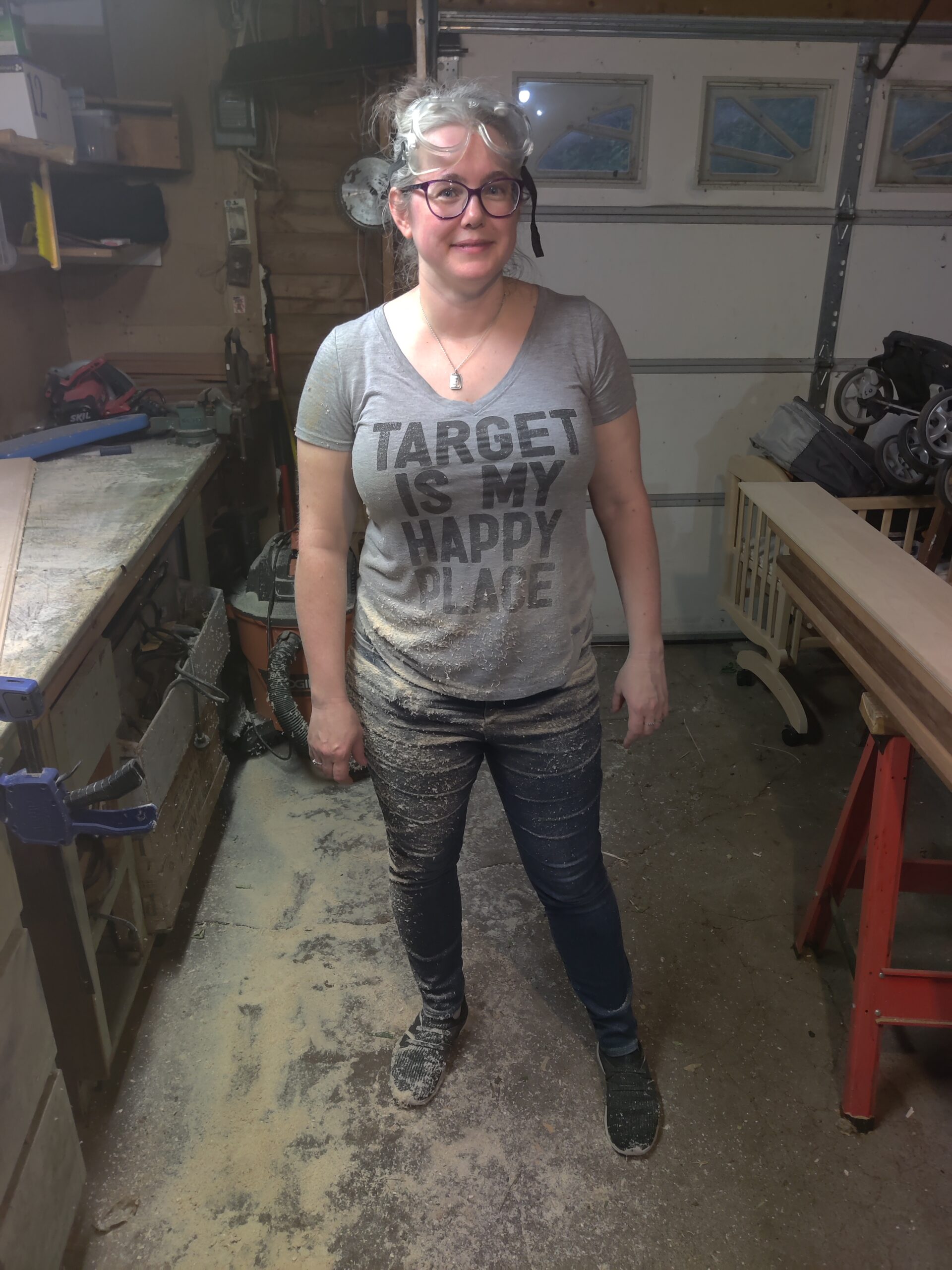 Mindy in a workshop covered in sawdust